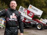 Greg Wilson in front of Hercules Tires branded sprint car. 
